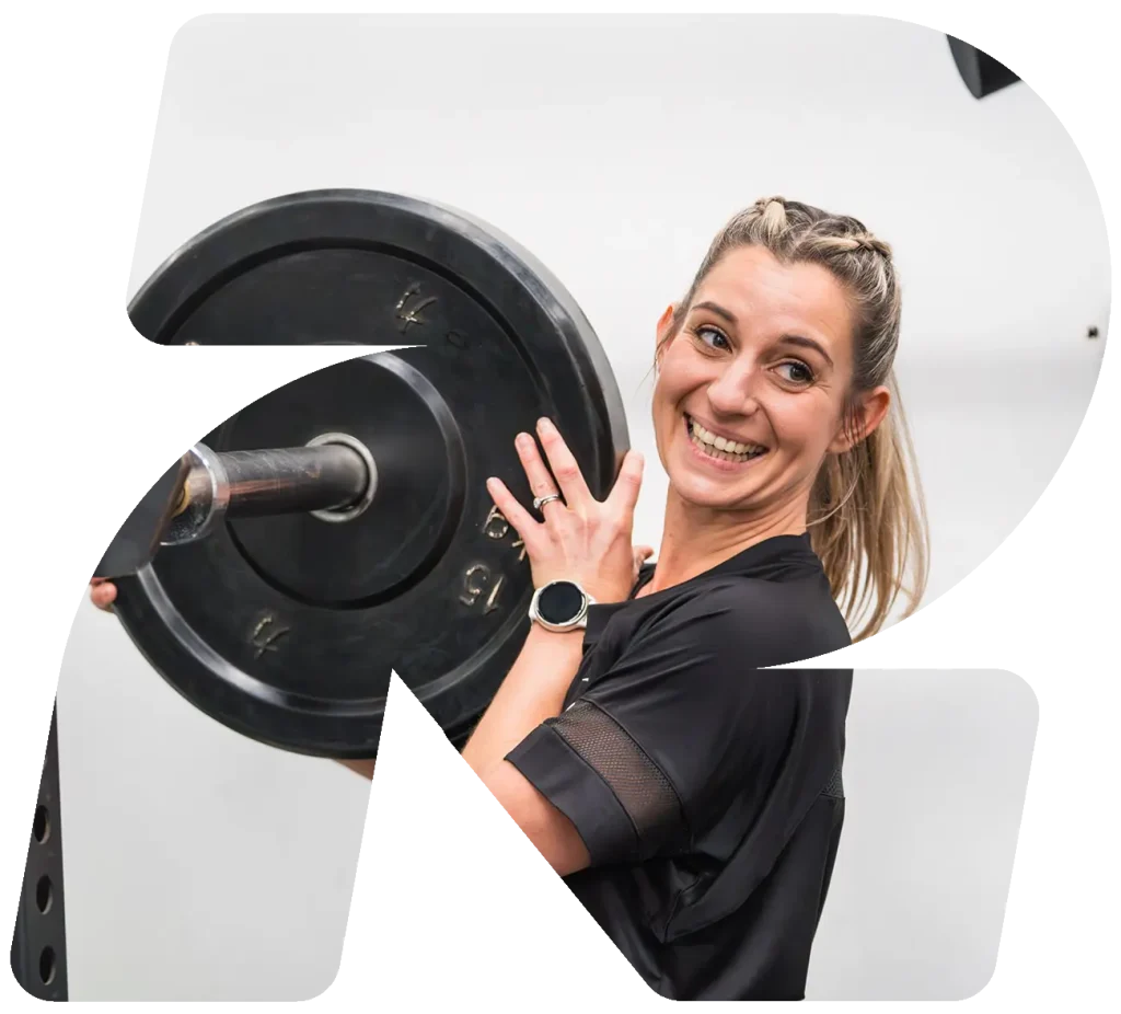 Someone putting weights onto a bench press at Rodney Fitness Centre